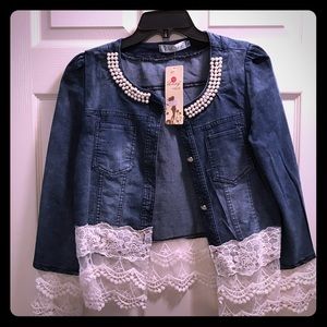 Blue jean jacket with lace trim.